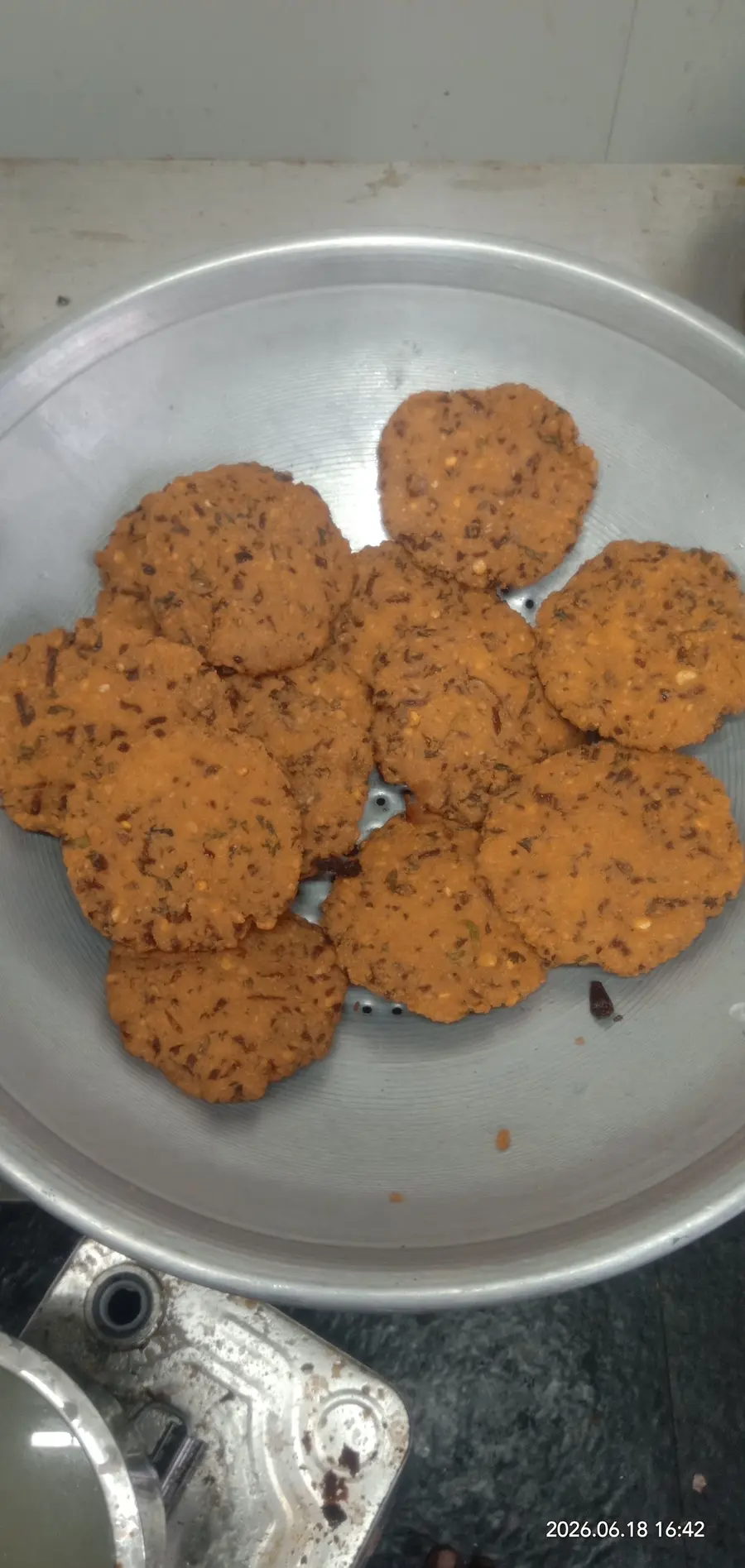 A plate of masala vadas, crisp and studded with curry leaves.